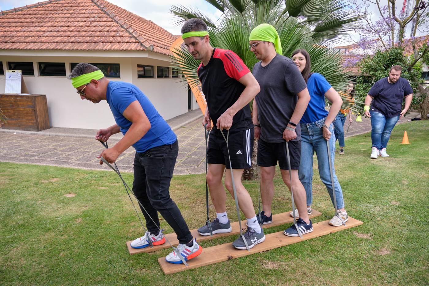 Teammates racing on wooden skis at the 2022 summer workshops